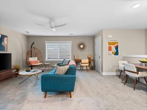 a living room with a blue couch and chairs at TC Parkside G: Spacious 2BR Condo in Traverse City