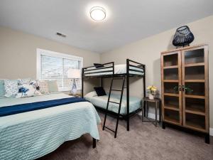 a bedroom with a bed and a bunk bed at TC Parkside G: Spacious 2BR Condo in Traverse City