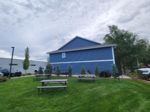 a group of benches in the grass in front of a building at TC Parkside G: Spacious 2BR Condo in Traverse City