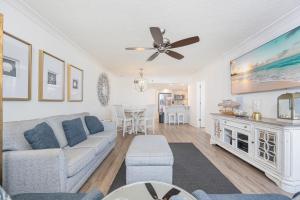 a living room with a couch and a ceiling fan at Phoenix VI 6906 in Orange Beach