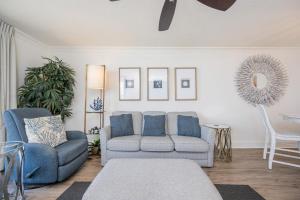 a living room with a couch and a chair at Phoenix VI 6906 in Orange Beach