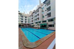 a swimming pool in front of a building at Bombinhas summer bech in Bombinhas +3 photos