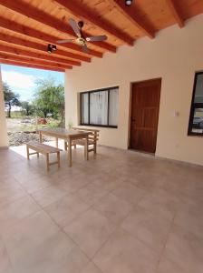 a large patio with a table and benches at Algarrobos in Cafayate
