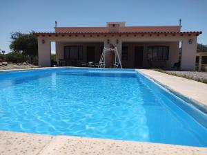a swimming pool in front of a house at Algarrobos in Cafayate