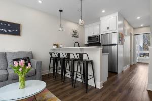 a kitchen and living room with a couch and a table at SkyBox|Rooftop|Downtown in Traverse City
