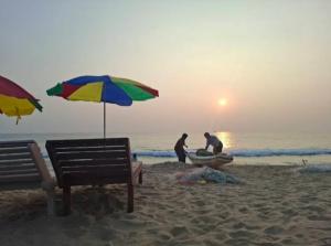 a group of people working on a boat on the beach at Dolphin beach resort in Varkala +6 photos