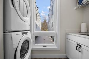 a washer and dryer in a kitchen with a window at SkyBox|Rooftop|Downtown in Traverse City