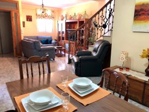 a dining room with a table and a living room at Casa Vista Hermosa Rute in Rute