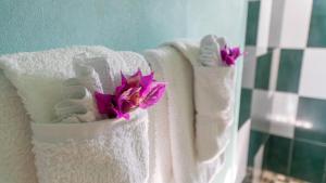 two towels with flowers in them on a couch at Lamblion Holiday Apartment in Freemans +67 photos
