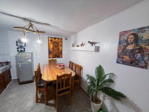a dining room with a table and a refrigerator at Jurassic Surf House Anza in Agadir +35 photos