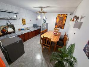 a kitchen with a wooden table and a dining room at Jurassic Surf House Anza in Agadir