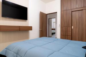 a bedroom with a bed and a flat screen tv at Casa Romina in La Paz