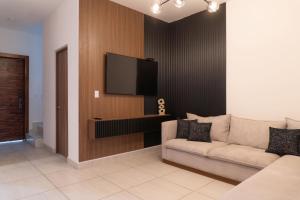 a living room with a couch and a flat screen tv at Casa Romina in La Paz