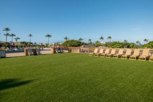 a lawn with chairs and a row of tables and chairs at Kaanapali Maui at the Eldorado by OUTRIGGER - Select Your Unit in Lahaina +8 photos