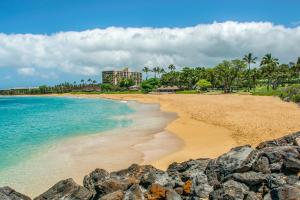 a beach with rocks in front of the ocean at Kaanapali Maui at the Eldorado by OUTRIGGER - Select Your Unit in Lahaina