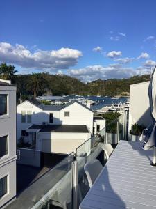 a balcony with a view of a city at Harbourview Penthouse Apartment in Whitianga +7 photos