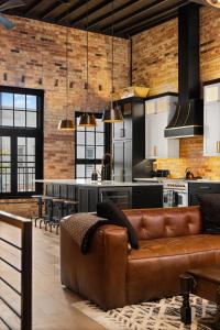 a living room with a couch and a kitchen at Luxury TC Loft: Historic Condo! in Traverse City