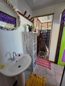 a bathroom with a sink and a shower at Pension Tipapa in Tikehau