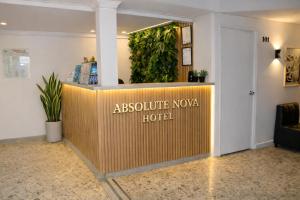 a sign that says absolute novo hotel in a lobby at Absolute Nova Hotel in Medellín