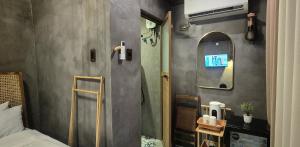 a small bathroom with a shower and a mirror at Casa Elia San Juan La Union Beach Cabin in San Juan