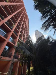a tall building with palm trees in front of it at The Reforma 27 Grand in Mexico City