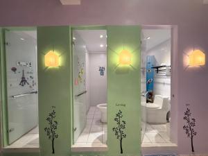a bathroom with a shower and a toilet and two lights at G.S. Holiday Home in Guanshan +58 photos