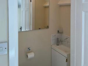 a bathroom with a sink and a mirror at Willow Nook in Whitby +12 photos