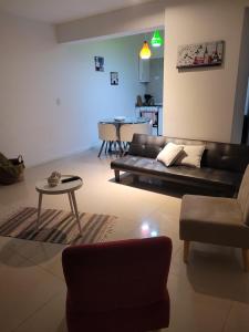 a living room with a couch and a table at Departamento morderno y centrico-Paseo Plaza in Navarro