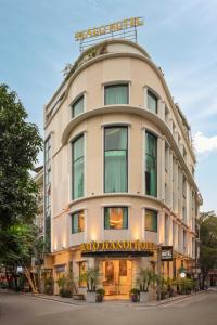 a large white building with a happy hampton honolulu hotel at HALO HANOI HOTEL in Hanoi