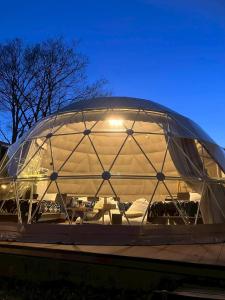 a large glass dome with chairs inside of it at Morethan Paradise in Nagatoro