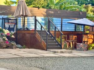 a house with a staircase and an umbrella at Private 1-Bedroom Villa with Pool & View in Kingston in Kingston