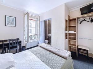 a bedroom with a bed and a desk and a sink at HOTEL WATTIGNIES in Paris