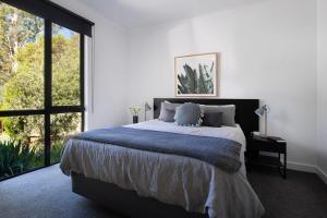a bedroom with a large bed and a large window at Ablac House in Glenlyon