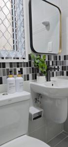 a white bathroom with a sink and a mirror at Nala Host - 2BR Garden Home in Hulhumale +22 photos