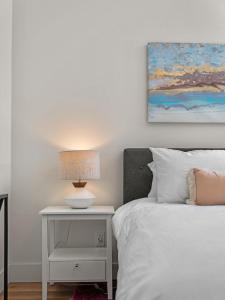 a bedroom with a bed and a table with a lamp at Cozy Capri Condo: Charming 1BR 1BA Downtown! in Traverse City