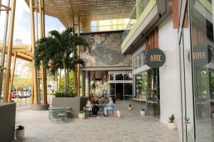 a group of people sitting outside of a shopping mall at Crystalbrook Bailey in Cairns