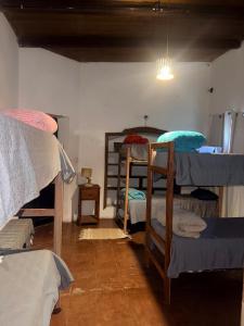 a room with several bunk beds in a room at Casona de los Molles in Tilcara