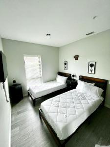 a bedroom with two beds and a window at Monochrome Den in Des Moines