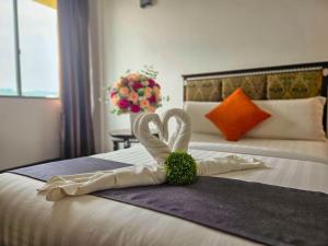 a hotel room with a heart made out of towels on a bed at Swing & Pillows - Bandar Kuantan in Kuantan