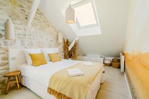 a bedroom with a white bed and a window at Maison Soleil Levant in Vernon