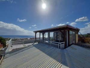 a large deck with a gazebo on a roof at la tête dans les nuages in Basse-Terre +9 photos