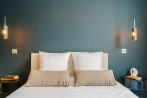a bed with white sheets and pillows in a bedroom at Maison Kolsaas in Vernon