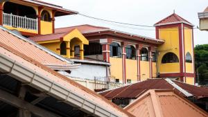 a group of buildings with roofs at Hotel HASA in Managua