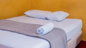 a bed with two pillows and a towel on it at Hotel HASA in Managua +30 photos