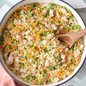 a pan filled with rice and vegetables with a wooden spoon at Peace and Quiet Dorm Rooms - Free Breakfast DIY Waffles - Free Dinner - Free Coffee - Longterm Ok! in Miami