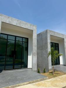 a modern house with a large glass door at Pearlix Koh Mook in Ko Mook