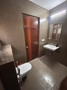 a bathroom with a toilet and a sink at Premium Villa Stay Near the Airport Perfect for Families & Business Travelers in Hyderabad +18 photos