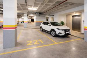 a white car parked in a parking lot at Affordable Luxury Apartment in Nouaseur
