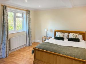 a bedroom with a large bed and a window at Island House - Uk51001 in Little Baddow