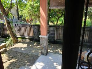 an outside view of a porch with a pole at Mangga in Sengkaling